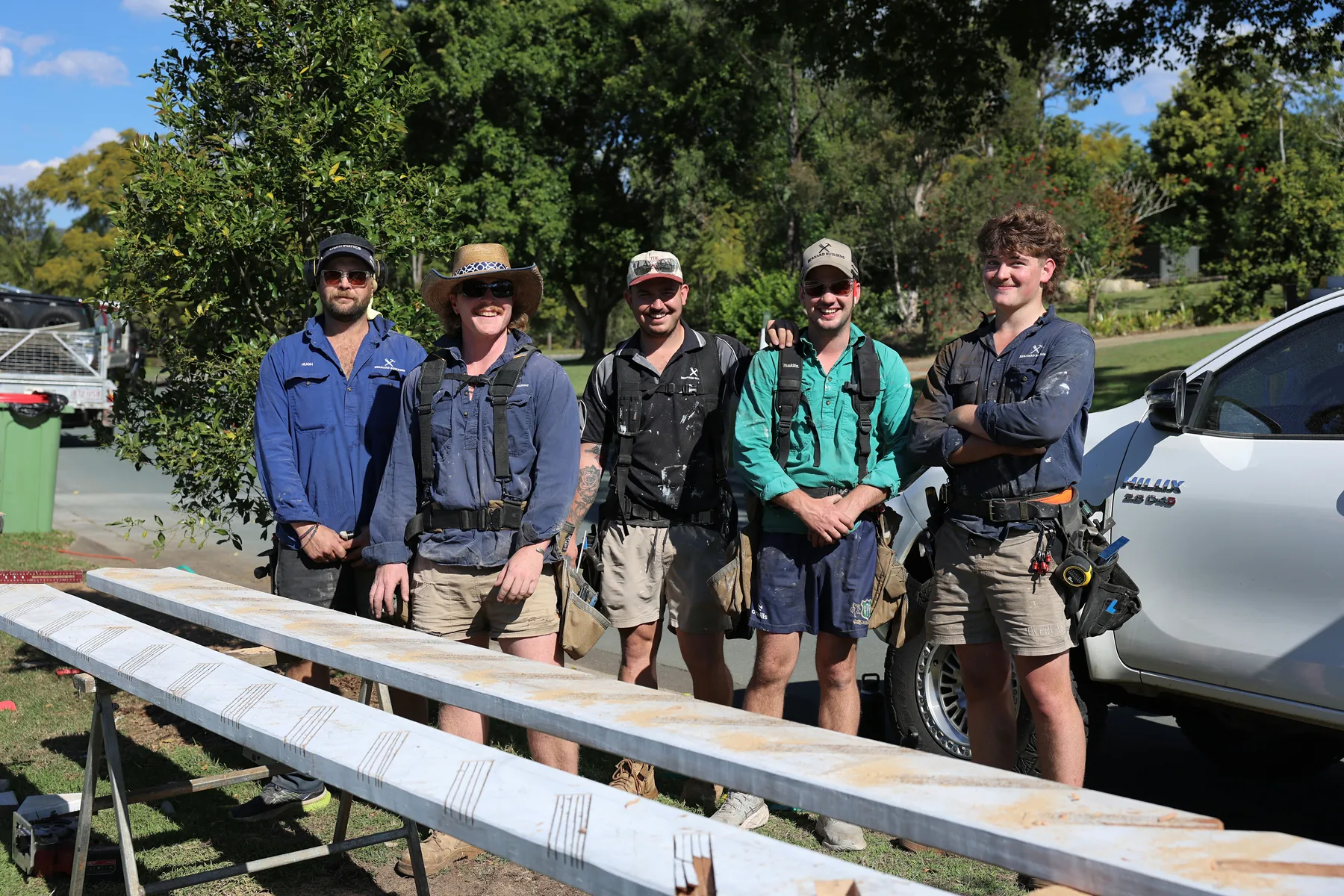 Ben Bernard, in the green shirt, with the Bernard Building crew beside the work ute