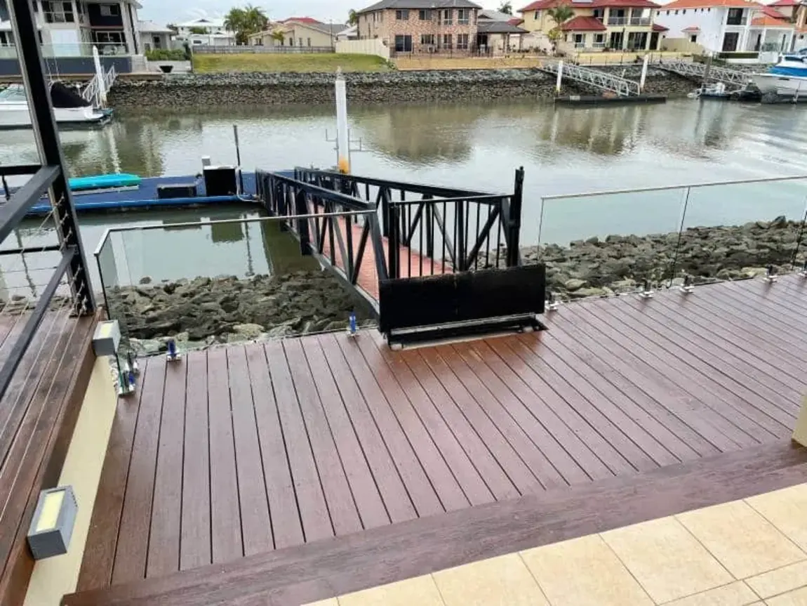 Completed timber deck with glass balustrade overlooking the water