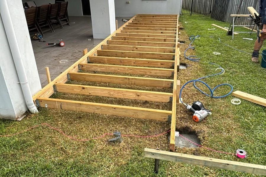 Deck subframe set out with string lines behind a Brisbane home