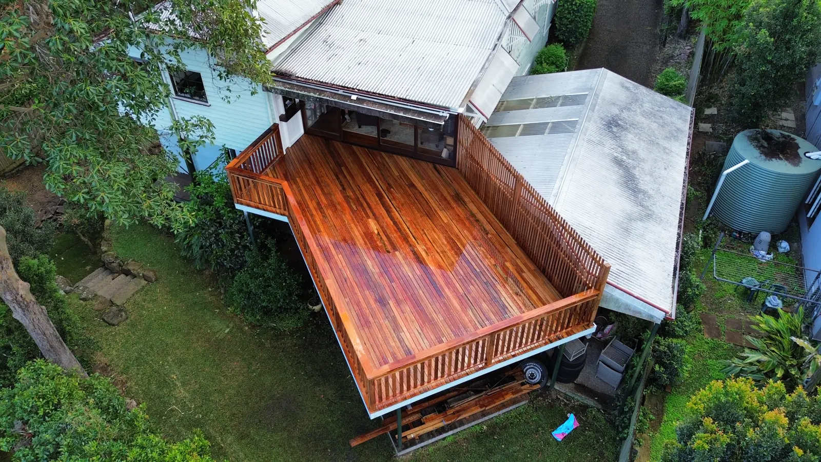Drone view of a freshly oiled hardwood deck with timber slat balustrade off the back of a Queenslander